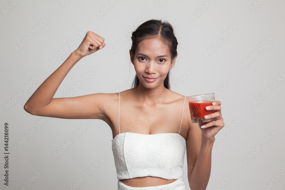 Strong healthy Asian woman with tomato juice. Strong healthy Asian woman with tomato juice.