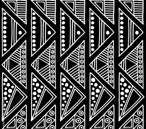 Seamless vector pattern. Black and white geometrical background with hand drawn decorative tribal elements. Print with ethnic, folk, traditional motifs. Graphic vector illustration.