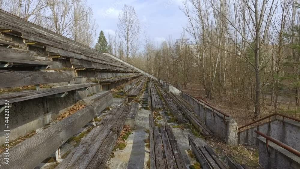 Ukraine, Pripyat, 6 april 2017: Crumbling tribunes of a sports stadium in the city of Pripyat Ukraine, Pripyat, 6 april 2017: Crumbling tribunes of a sports stadium in the city of Pripyat
