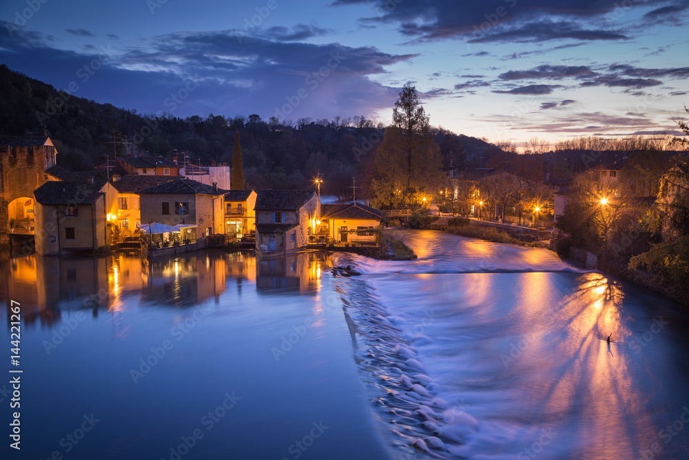 Valeggio sul Mincio, Veneto, Italy. Landscape view of the village during a colorful sunset. Valeggio sul Mincio, Veneto, Italy. Landscape view of the village during a colorful sunset.