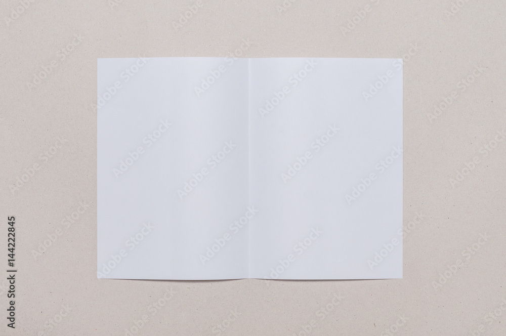 Bifold white template paper on grey background Bifold white template paper on grey background