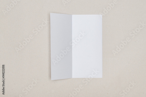 Trifold white template paper on grey background © Kittichai