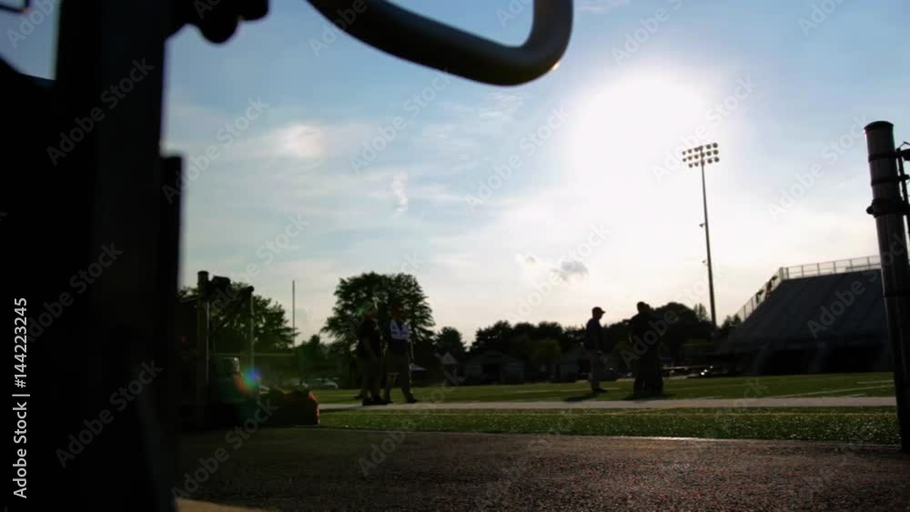 Coaches walk on an empty football field Coaches walk on an empty football field