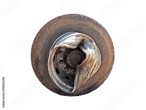 Dirty and broken tire truck wheel after the accident, damaged rim of the wheel of the truck, isolated on white background