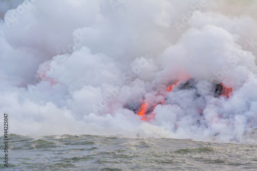 Amazing view of lava pouring into the sea in Volcanoes National Park, Big Island, Hawaii © Fominayaphoto
