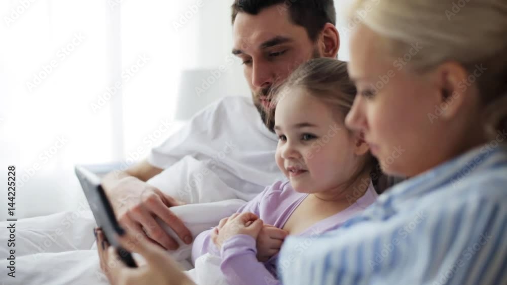 happy family with tablet pc in bed at home happy family with tablet pc in bed at home