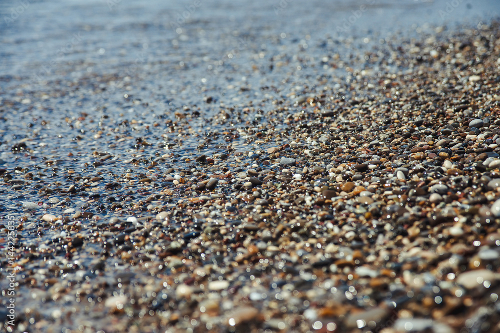 Close up of a pebble beach with the sea. Close up of a pebble beach with the sea.