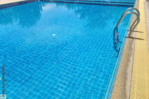 Swimming pool with stair and blue relaxing water © gbaitong