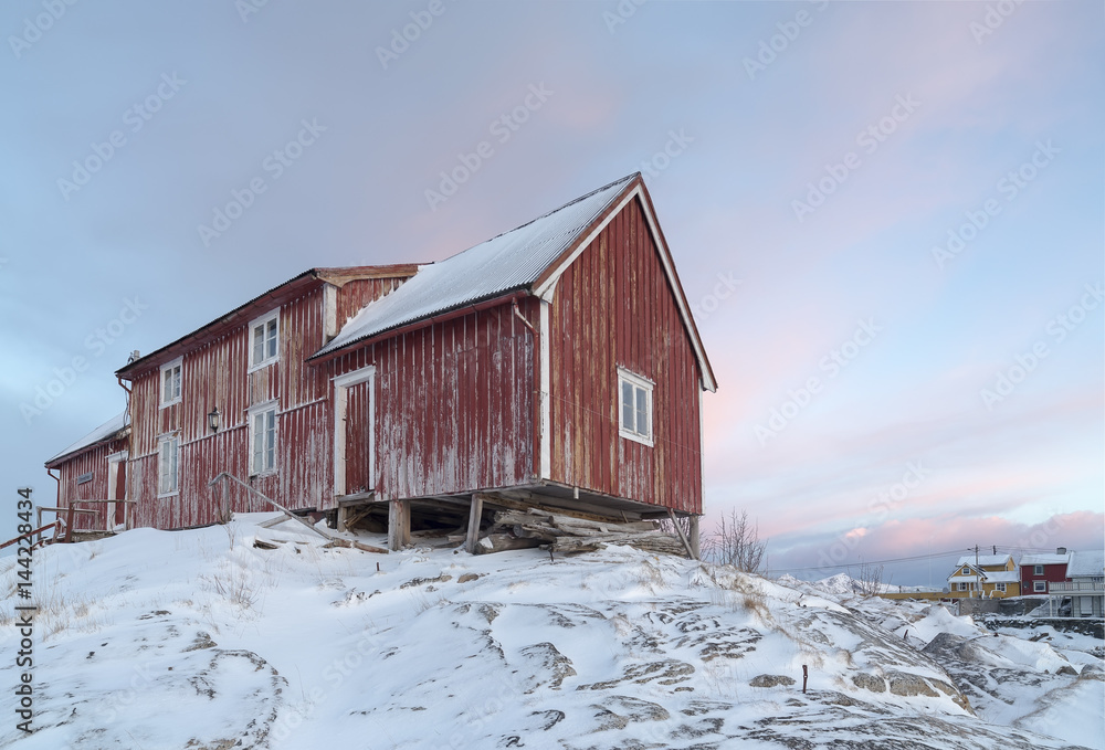 Typical Norwegian Home with colourful sky on the background, Lofoten Islands, Norway Typical Norwegian Home with colourful sky on the background, Lofoten Islands, Norway