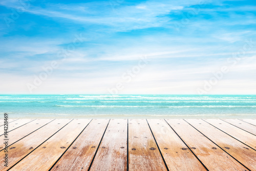 Empty wooden table with party on beach background blurred. Concept Summer, Beach, Sea, Relax, Party.