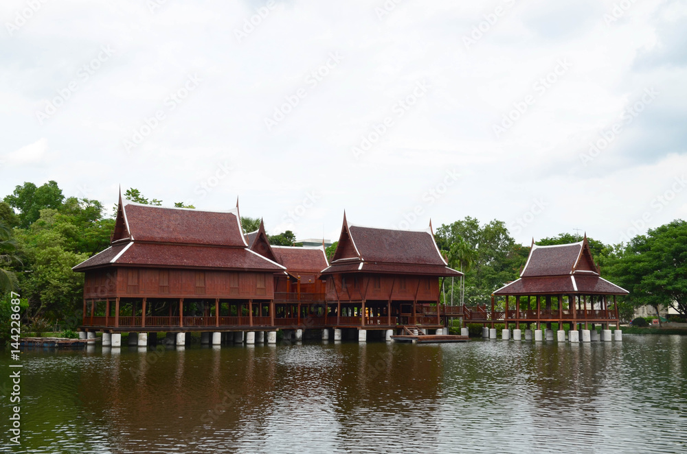 Group of beautiful traditional Thai house in pond