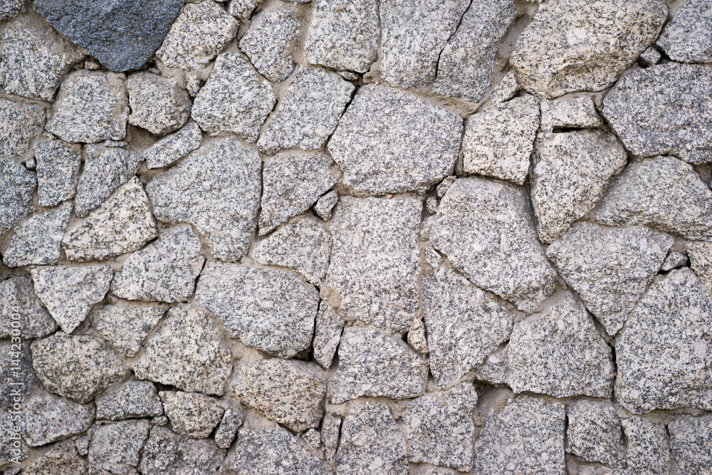 the texture of the stone wall. Granite the texture of the stone wall. Granite