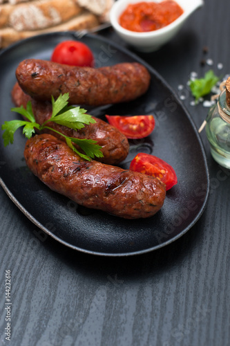 Fried sausages with herbs in a pan