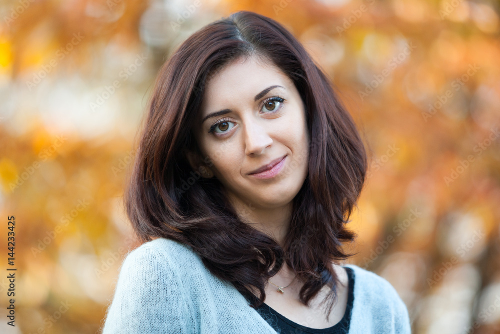 Portrait of a beautiful brunette on a background of foliage. Portrait of a beautiful brunette on a background of foliage.