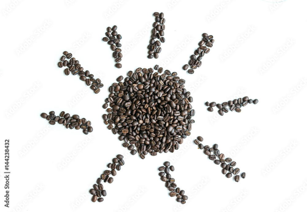 Coffee beans are arranged in a sun image with copy space. Coffee beans are arranged in a sun image with copy space.
