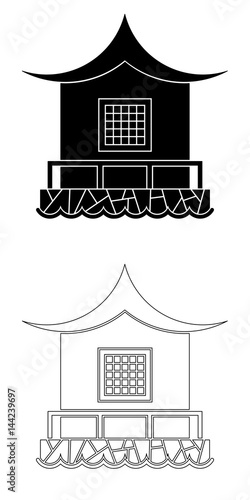 Architecture of the Far East. House in the eastern style with a barrier on a stone base near the water.