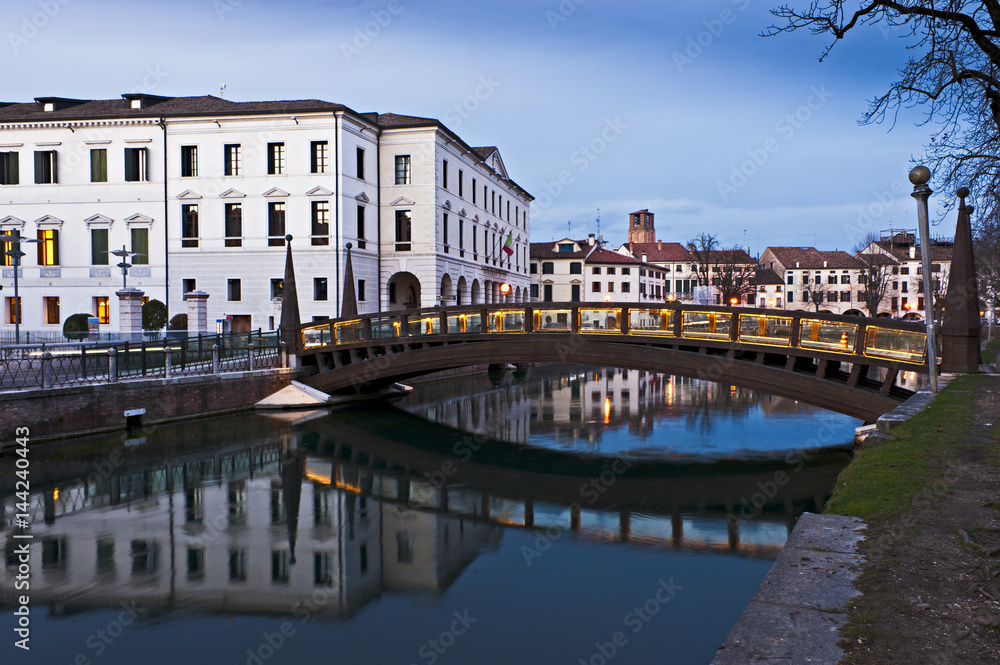 The University Bridge reflects on river Sile in Treviso. Italy
