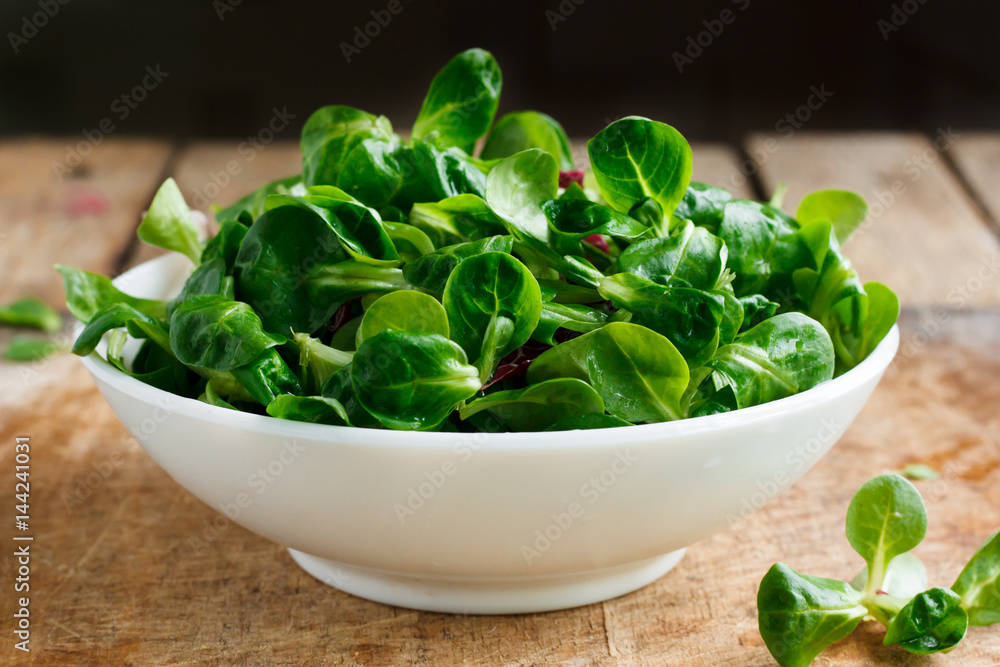 Fresh corn salad in a white bowl on a wooden background Fresh corn salad in a white bowl on a wooden background