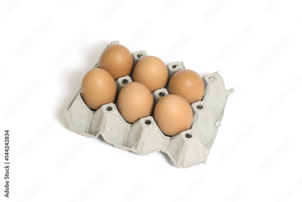 Six chicken eggs in egg box isolated on white background