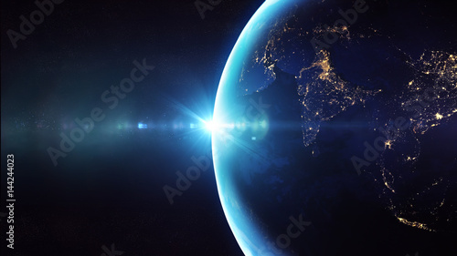 Fototapeta Naklejka Na Ścianę i Meble -  Blue sunrise, view of earth from space/Planet earth sunrise meets the city lights. Some elements of this image furnished by NASA