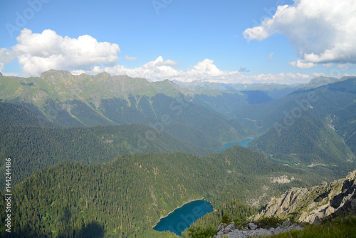 A view from the air on two blue lakes, which is located among the pine forest, in a bowl of mountain ranges, Malaya Ritsa, Abkhazia