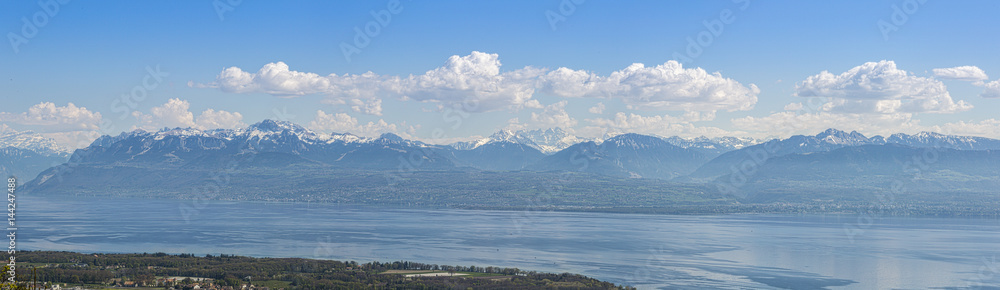 Panoramic view Lake Geneva and surrounding mountains during springtime.