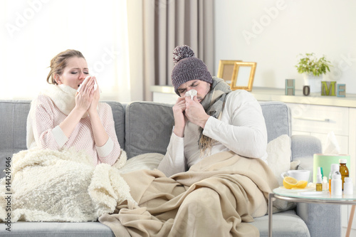Ill couple on couch at home