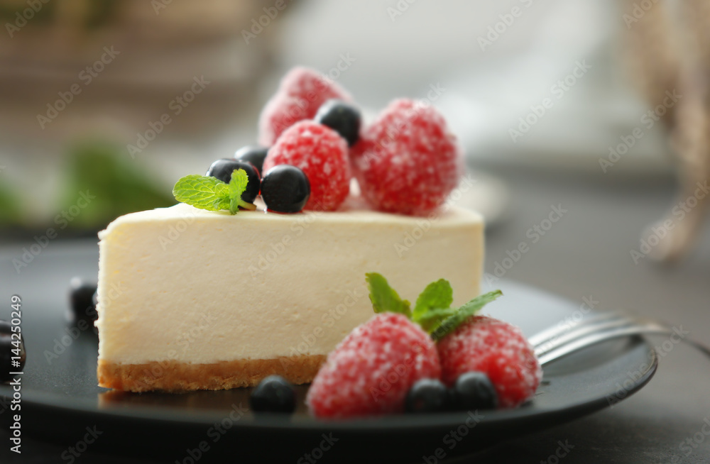Tasty cheesecake slice with berries on plate