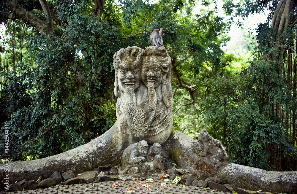stone sculpture of a group of monkeys live monkey in a tropical green forest stone sculpture of a group of monkeys live monkey in a tropical green forest