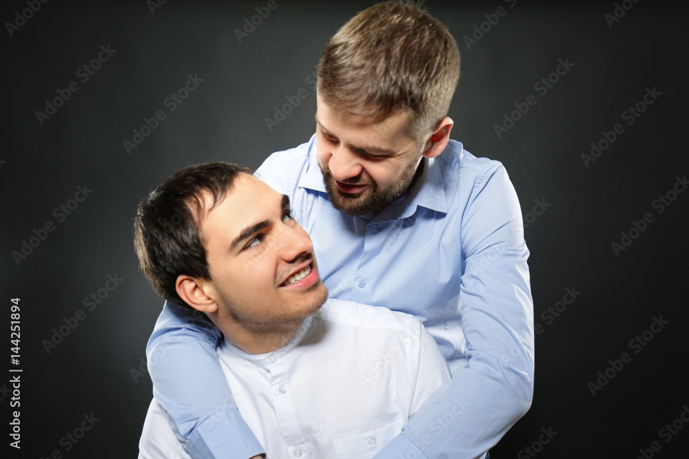 Happy gay couple on black background Happy gay couple on black background