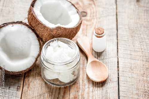 coconut oil for body care in cosmetic concept on old wooden table