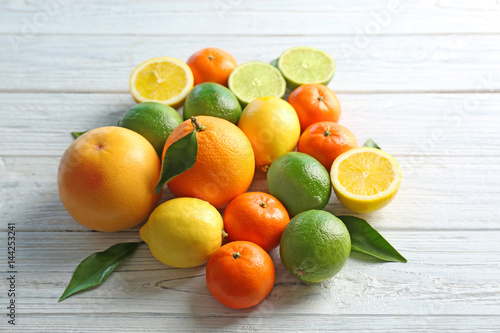 Beautiful composition of citrus fruits on wooden background © Africa Studio