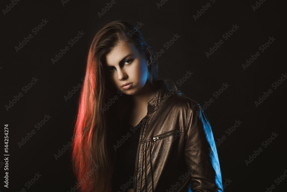Wondeful stylish woman posing at studio with red and blue light Wondeful stylish woman posing at studio with red and blue light