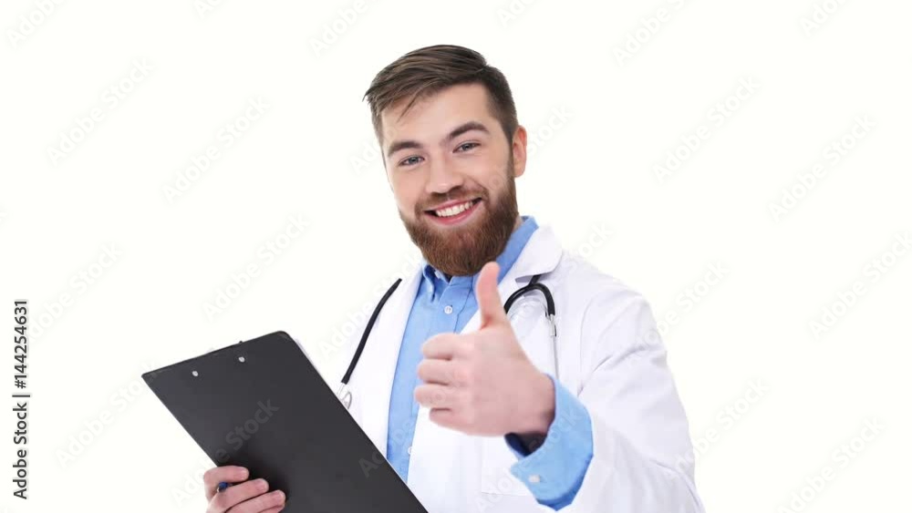 Cheerful male doctor with folder looking camera and showing thumb up isolated Cheerful male doctor with folder looking camera and showing thumb up isolated