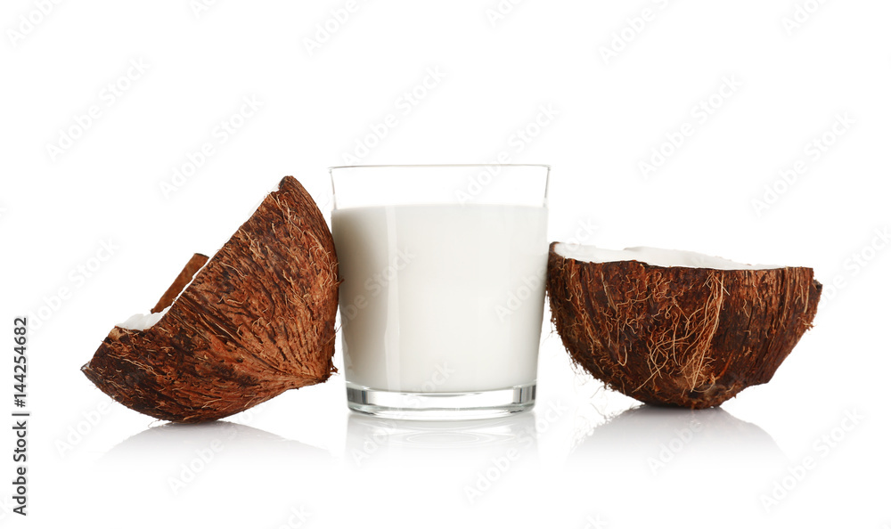 Glass of coconut milk with nut on white background Glass of coconut milk with nut on white background
