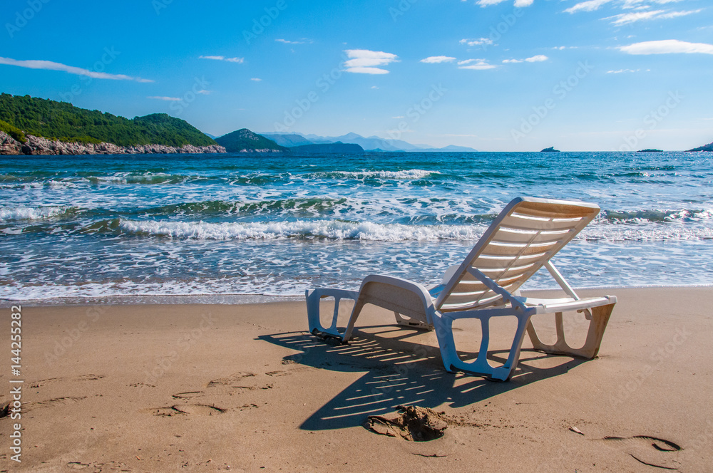  Deck chair on a beach looking out onto the sea
