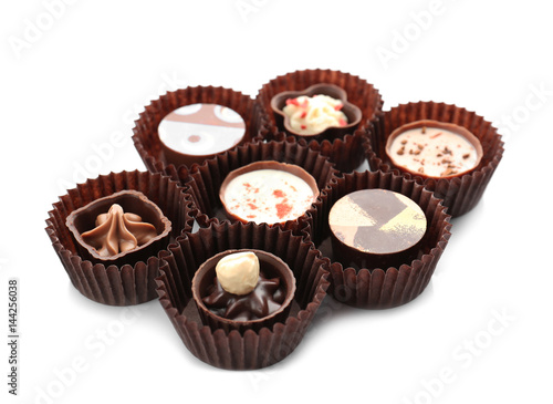 Delicious chocolate candies on white background