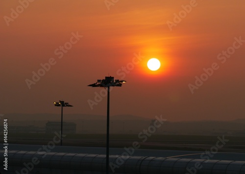 Photography Sunrise at the airport, Kuala Lumpur A red sun rises above the airport in Kuala