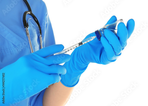 Nurse with syringe and medicine for vaccination on white background, closeup