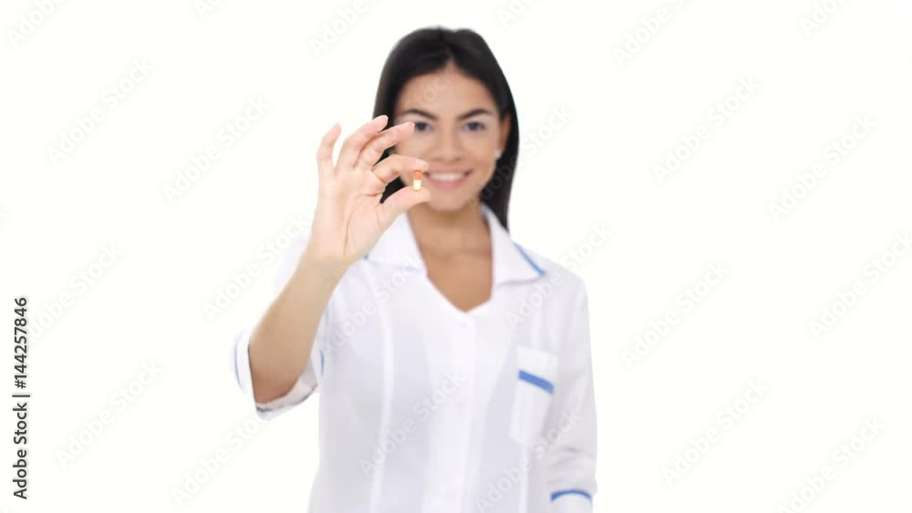 Closeup of red pill in nurse's hand isolated Closeup of red pill in nurse's hand isolated