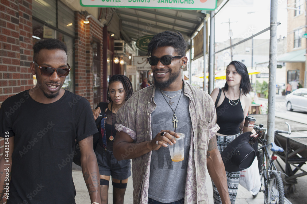 A group of friends walking down a street. A group of friends walking down a street.