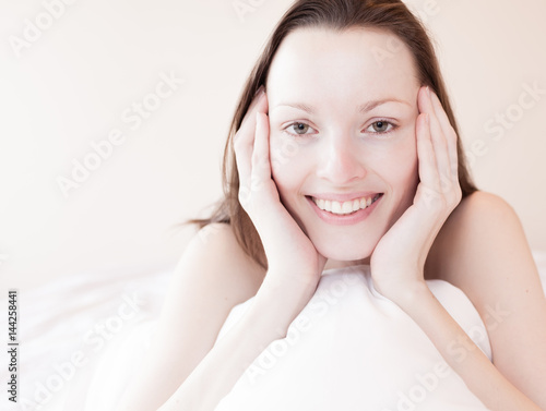 Beautiful woman smiling in bed. 