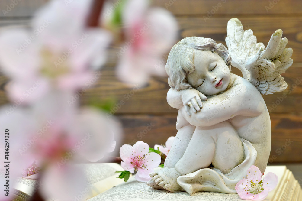 Angel and and spring flowers on wooden background Angel and and spring flowers on wooden background