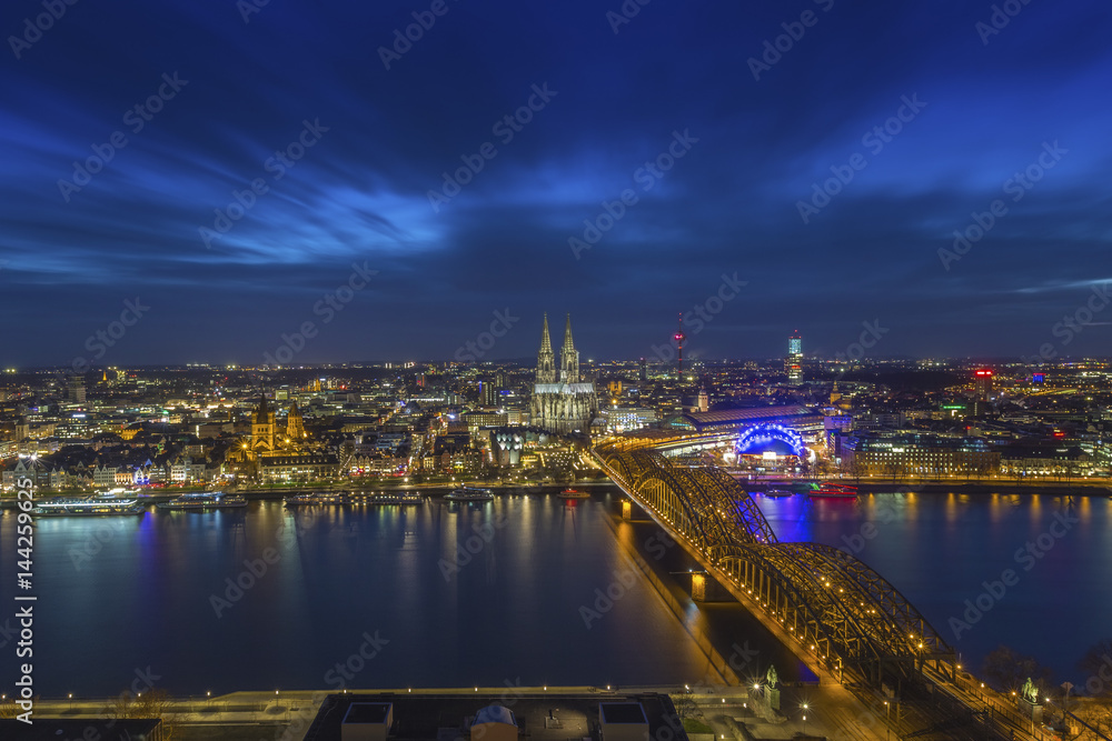 Cologne, Germany - Aerial skyline view of Cologne with the beautiful Cologne Cathedral, Rhine River and Hohenzollern Bridge by night