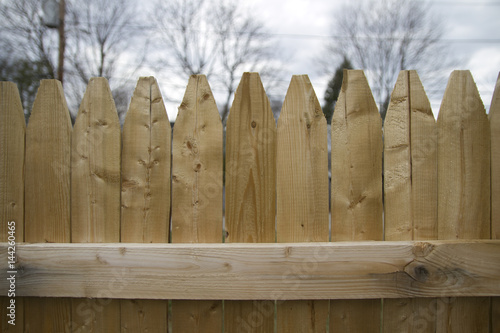 Close-Up of Wooden Stockade Privacy Fence with Picket Tops