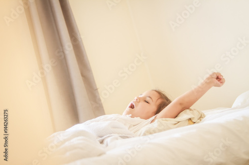 indoor portrait of young child girl wrapped in blanket