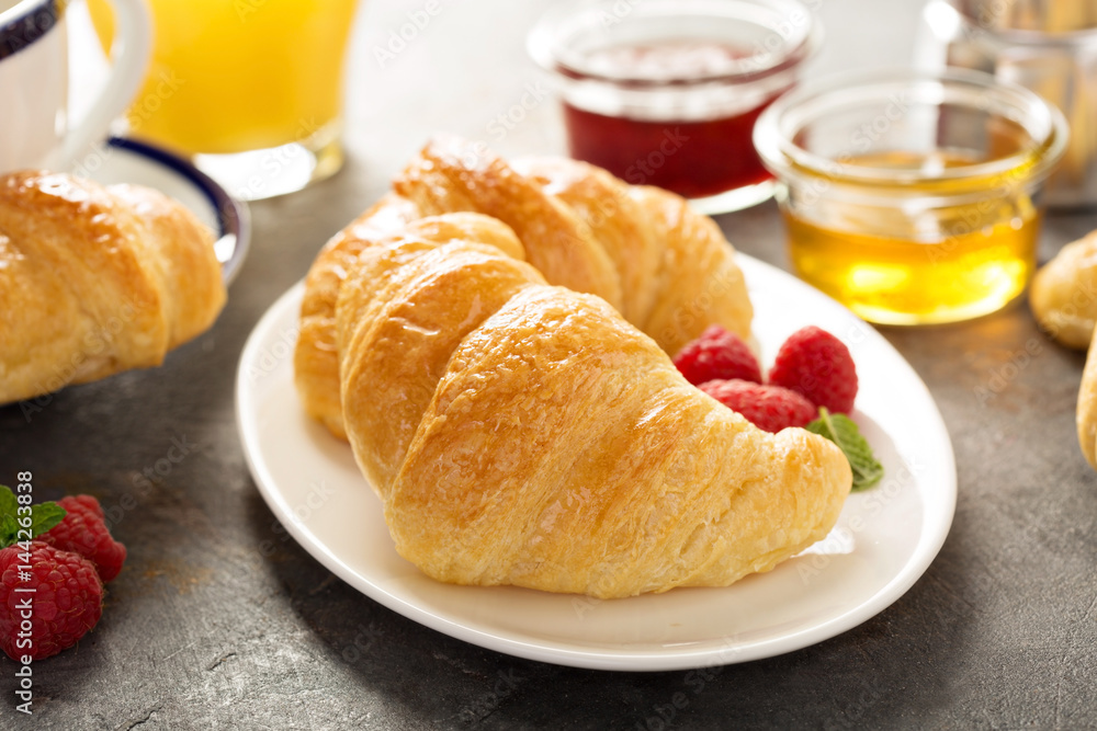 Freshly baked croissants with honey and jam Freshly baked croissants with honey and jam