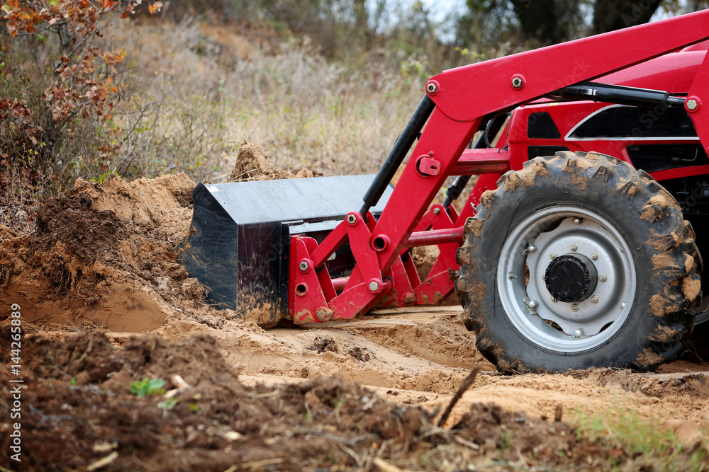 Tractor front end loader with dirt on construction side Tractor front end loader with dirt on construction side