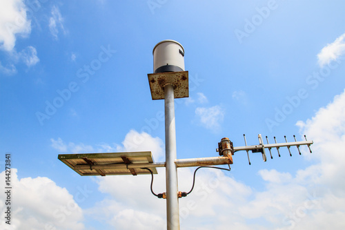 Rain gauge and solar panel from dam on cloud and blue sky space