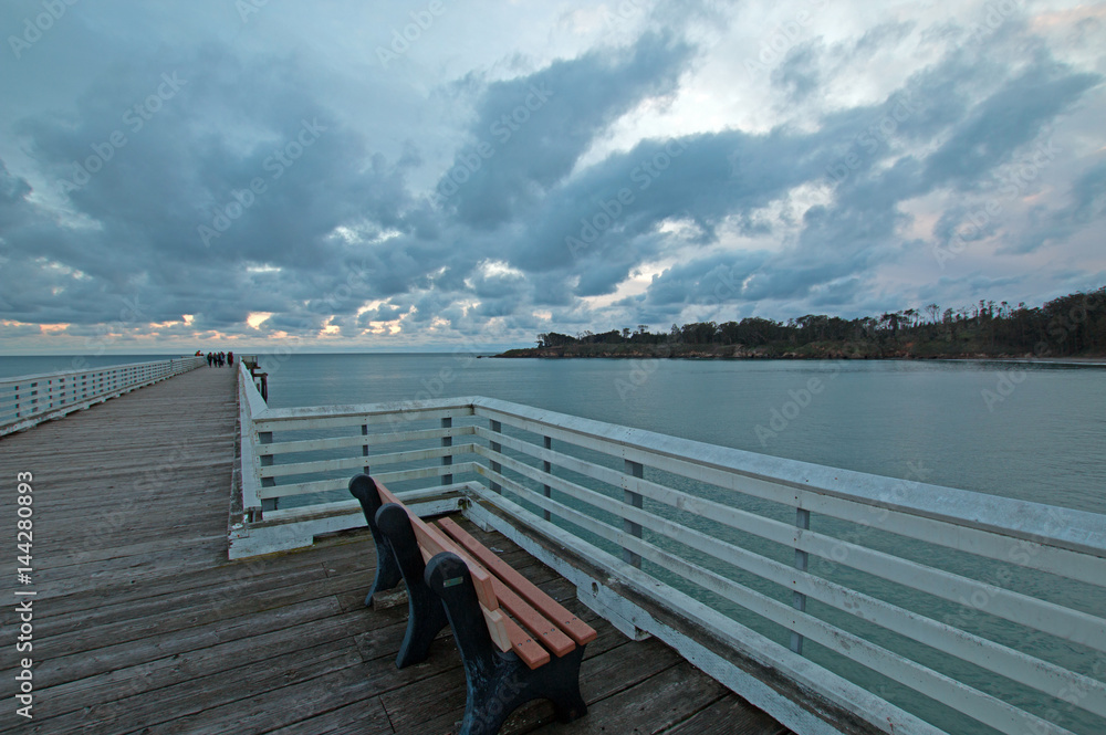 Bench on San Simeon Public Pier at sunset on the Central Coast of California USA